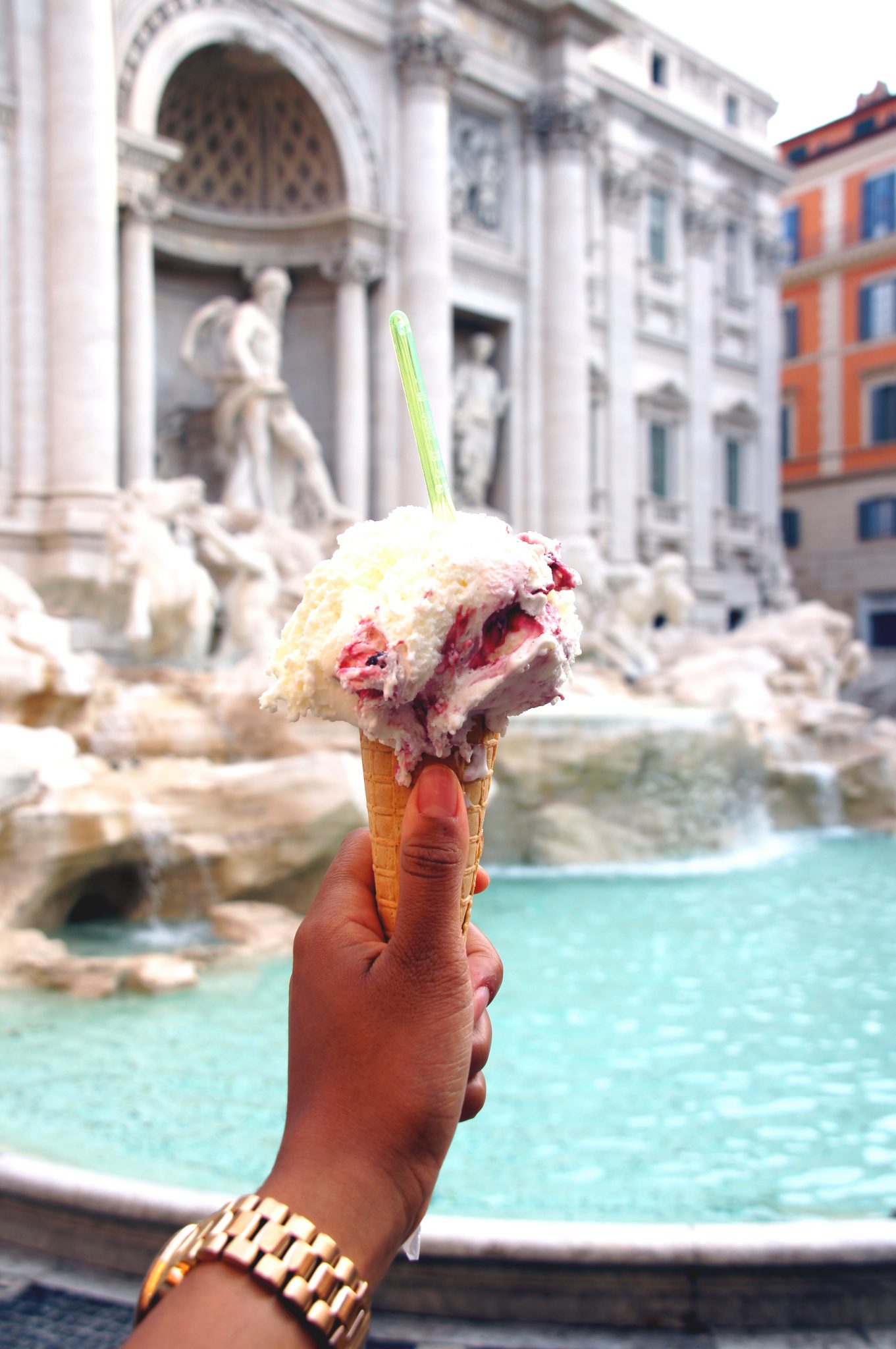 ice cream in front of the trevi fountain in rome