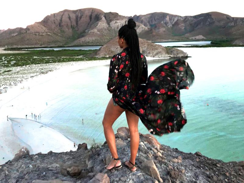 Miri wearing a floral Maxidress on a cliff