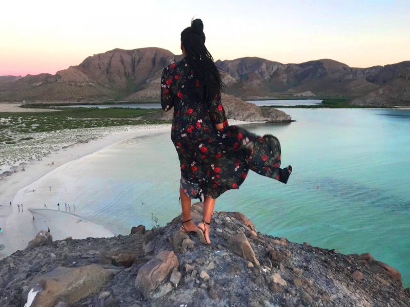 Miri wearing a floral Maxidress on a cliff