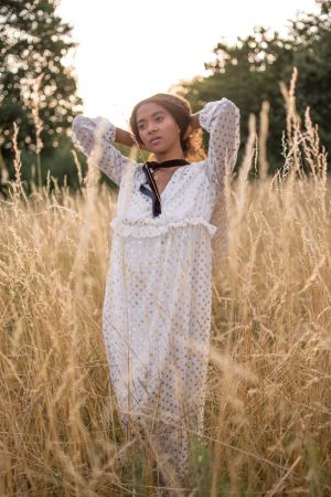 Girl wearing a maxi dress in a gold field Late Summer