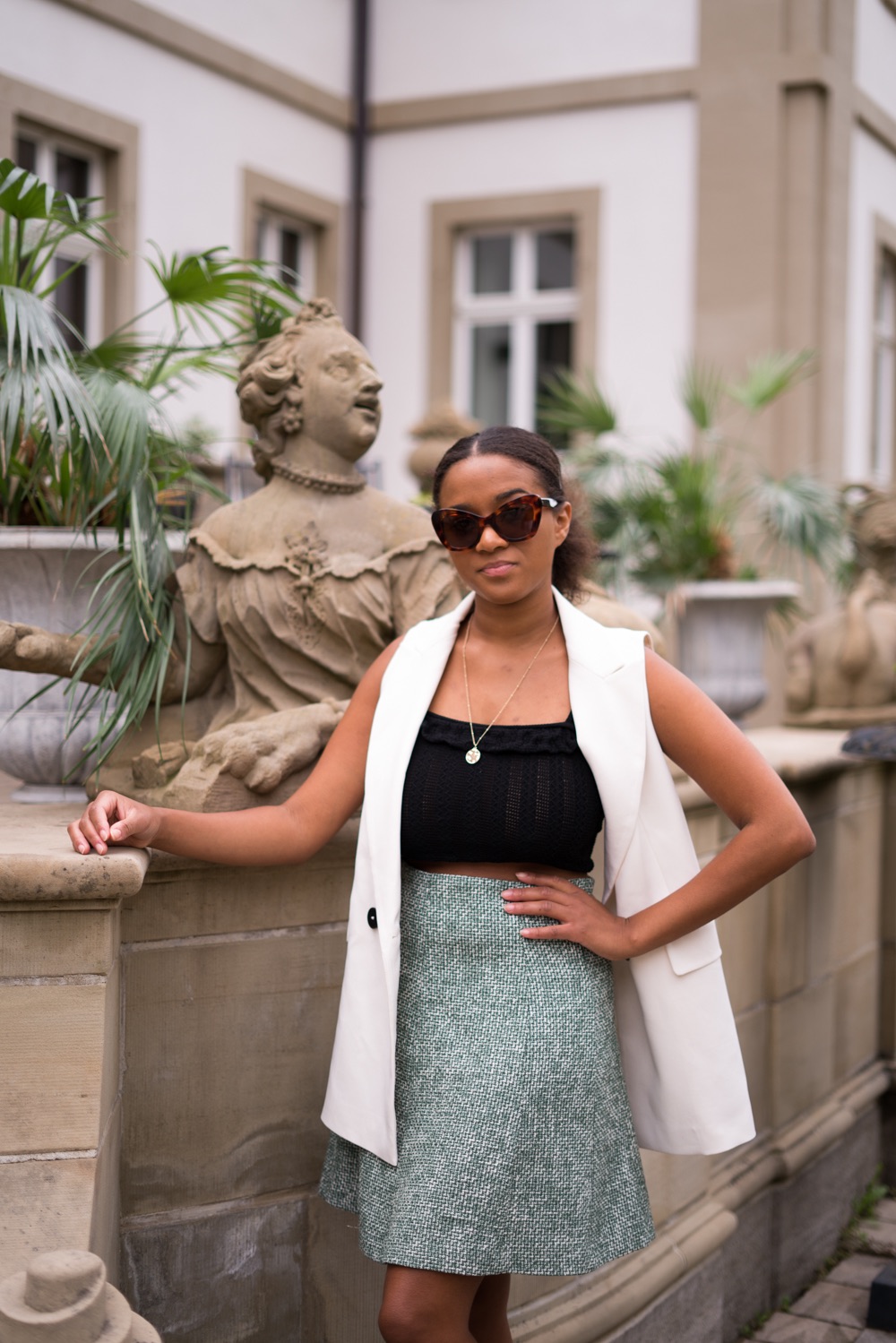 Black Fashion blogger wearing a long vest in summer
